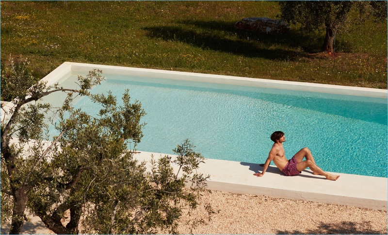 Relaxing poolside, Rodolphe Zanforlini sports Le Sirenuse Positano siren flowers print swim shorts $202.