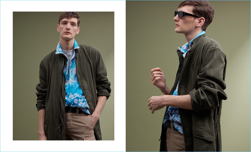 Model Yannick Abrath wears a Blue Blue Japan print short-sleeve shirt $500, Martine Rose logo-print t-shirt $173, and a Vince parka $700. The Belgian model also dons a Paul Smith leather belt $150, Incotex cargo shorts $287, and Stella McCartney sunglasses.