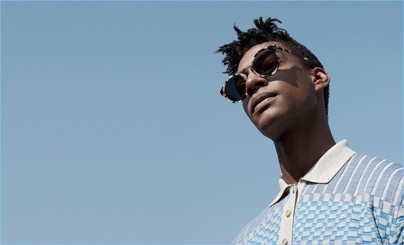 Ty Ogunkoya wears a check Orley polo $224 with Retrosuperfuture Panama round-frame sunglasses $214.