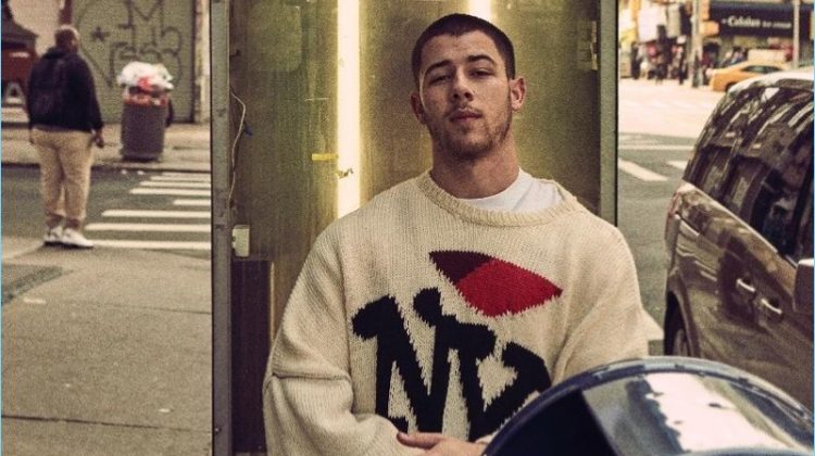 Venturing outdoors, Nick Jonas wears a Raf Simons NY sweater.