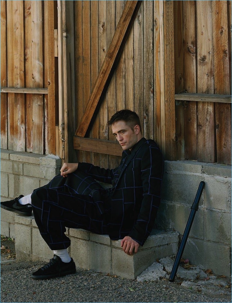 Venturing outdoors, Robert Pattinson wears an oversize check Dior Homme suit with his own sneakers.