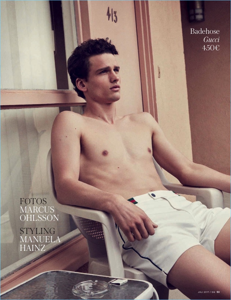 Simon Nessman sports Gucci swim shorts for the July 2017 issue of GQ Germany.