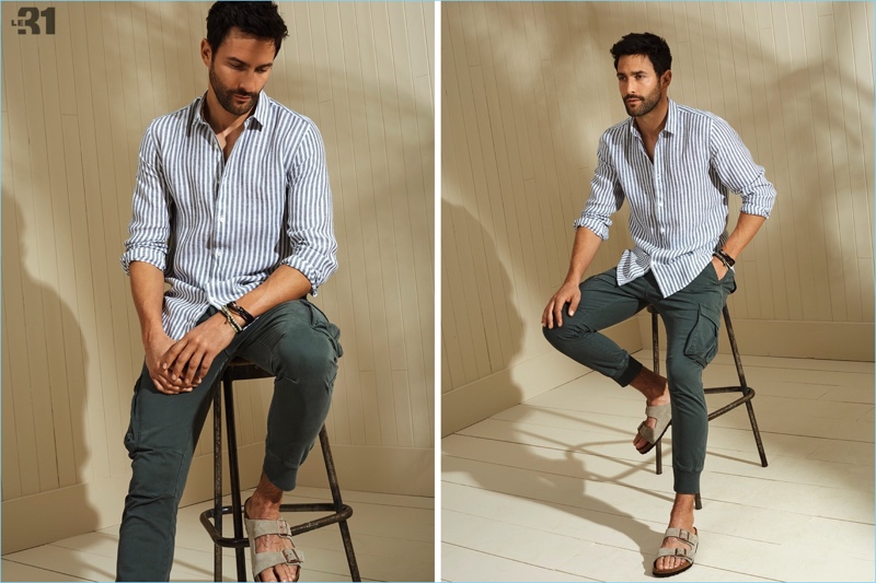 American model Noah Mills sports a LE 31 chambray stripe shirt and cargo joggers with Birkenstock sandals.