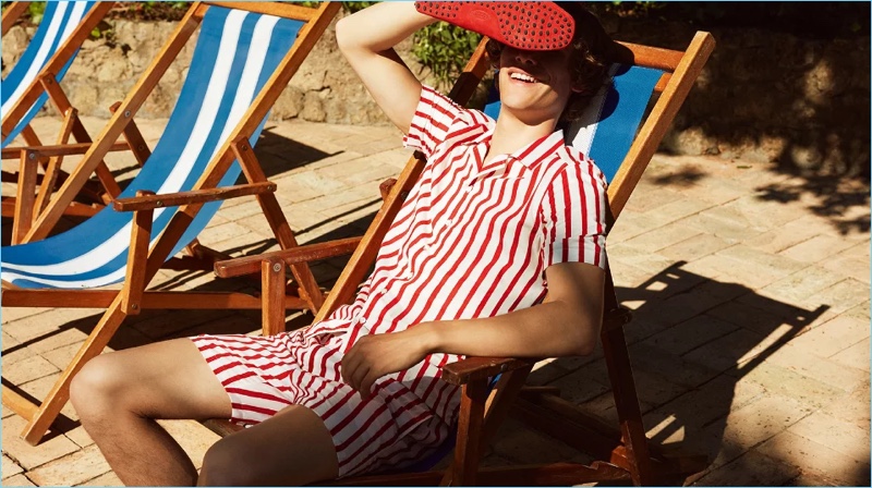 Bask in the sun with Tod’s Gommino suede driving shoes, camp-collar striped shirt $395 and swim shorts $295.