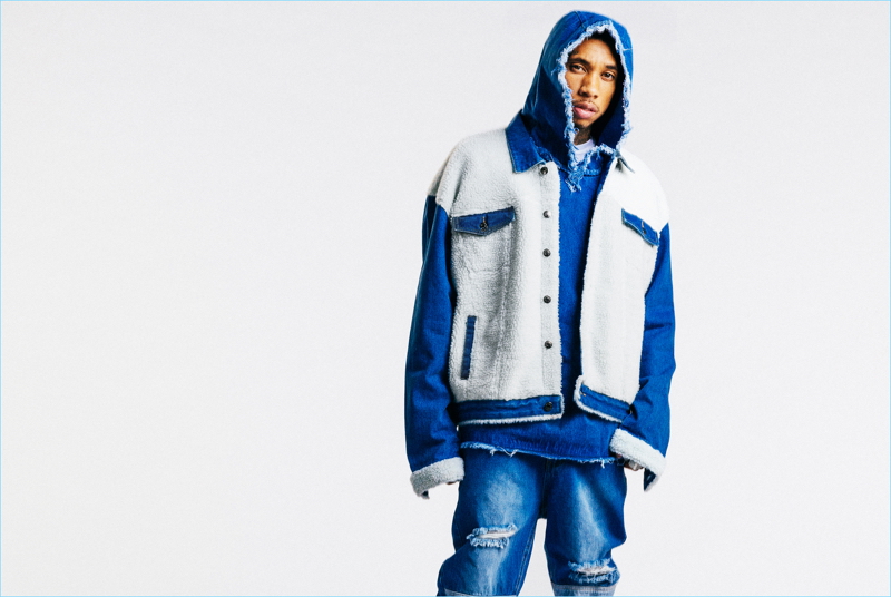 Collaborating with boohooMAN, Tyga wears an oversized distressed denim hoodie $52 and ripped jeans $40.