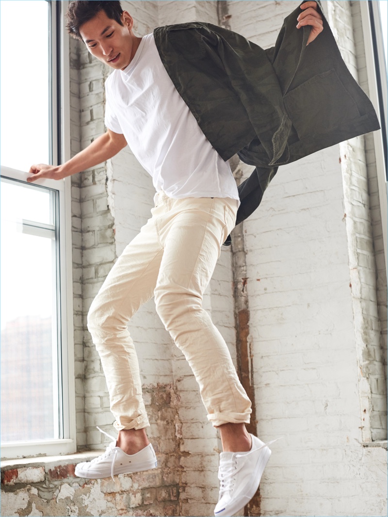 Captured in motion, Jae Yoo wears white Abercrombie & Fitch Felix super slim jeans $30.