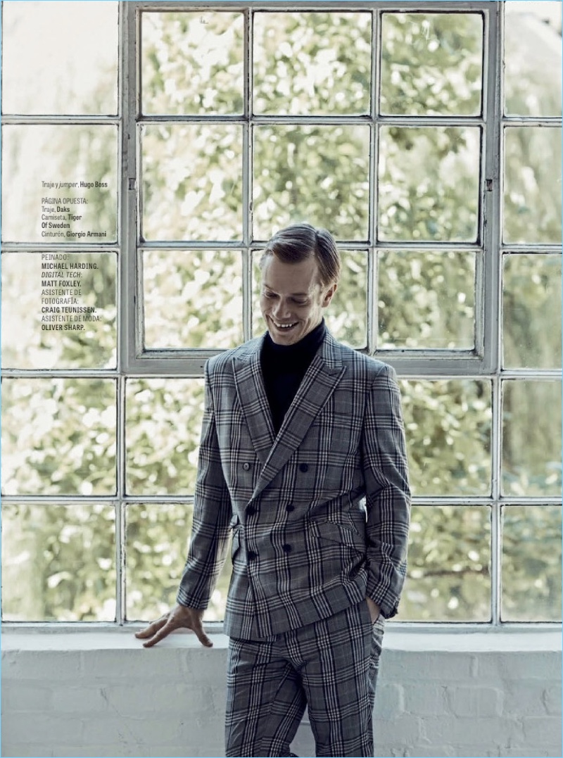 Suiting up for GQ México, Alfie Allen wears a check suit and turtleneck by Hugo Boss.