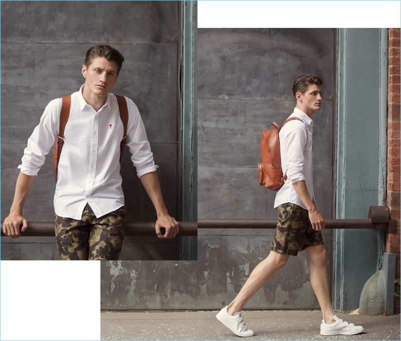 White Oxford: Eli Hall wears an AMI patch shirt $135 and Obey camouflage print shorts. He accessorizes with a Lotuff Leather backpack $1,100 and Buddy sneakers $255.