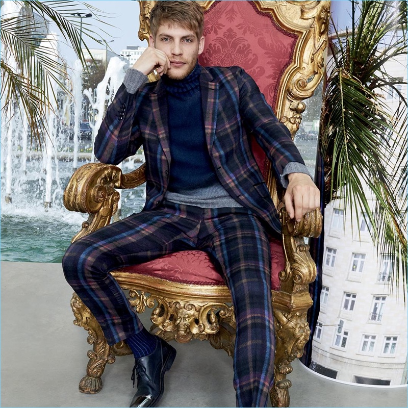 French model Baptiste Radufe dons a plaid suit and navy turtleneck for Etro's fall-winter 2017 campaign.