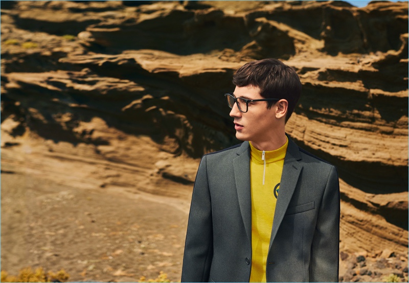 Wearing glasses, Nicolas Ripoll also sports a trim blazer and half-zip top for Fendi's fall-winter 2017 men's campaign.