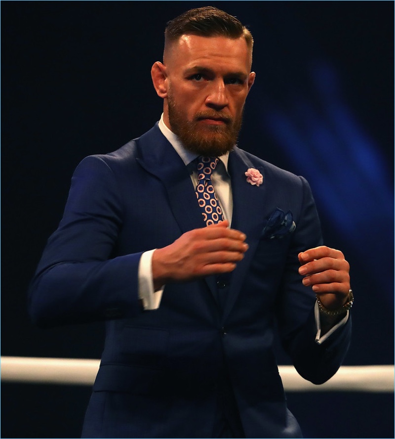 Traveling across the pond, Conor McGregor plays it modest in a navy David August suit.