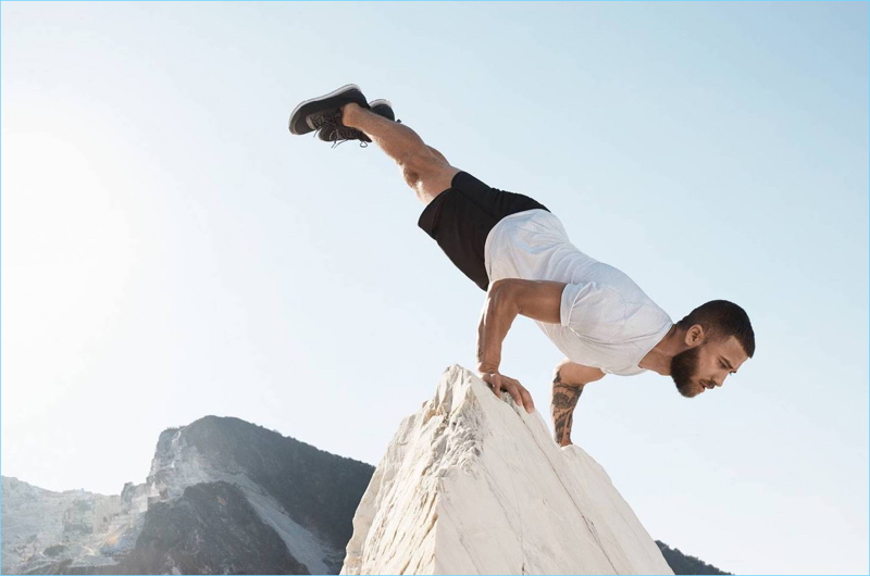 Doing yoga, Patrick Beach wears a H&M short-sleeved sports shirt $14.99 and shorts $29.99.