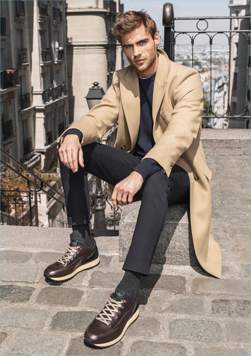 George Alsford wears Hogan's brown sneakers for the brand's fall-winter 2017 campaign.