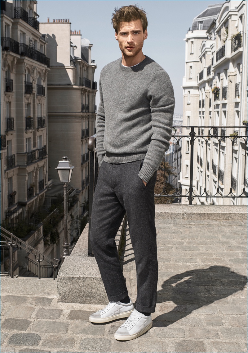 Wearing all grey, George Alsford shows off white and grey sneakers for Hogan's fall-winter 2017 campaign.