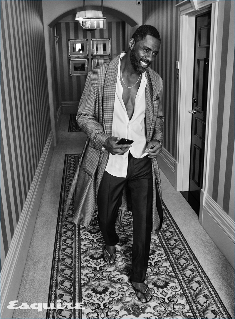 Actor Idris Elba dons a Paul Stuart robe with a shirt and trousers by Louis Vuitton. He also wears Havaianas sandals.
