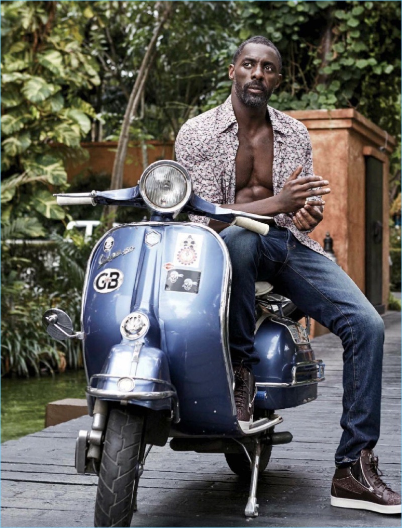 Wearing an open shirt, Idris Elba appears in a photo shoot for Essence magazine.