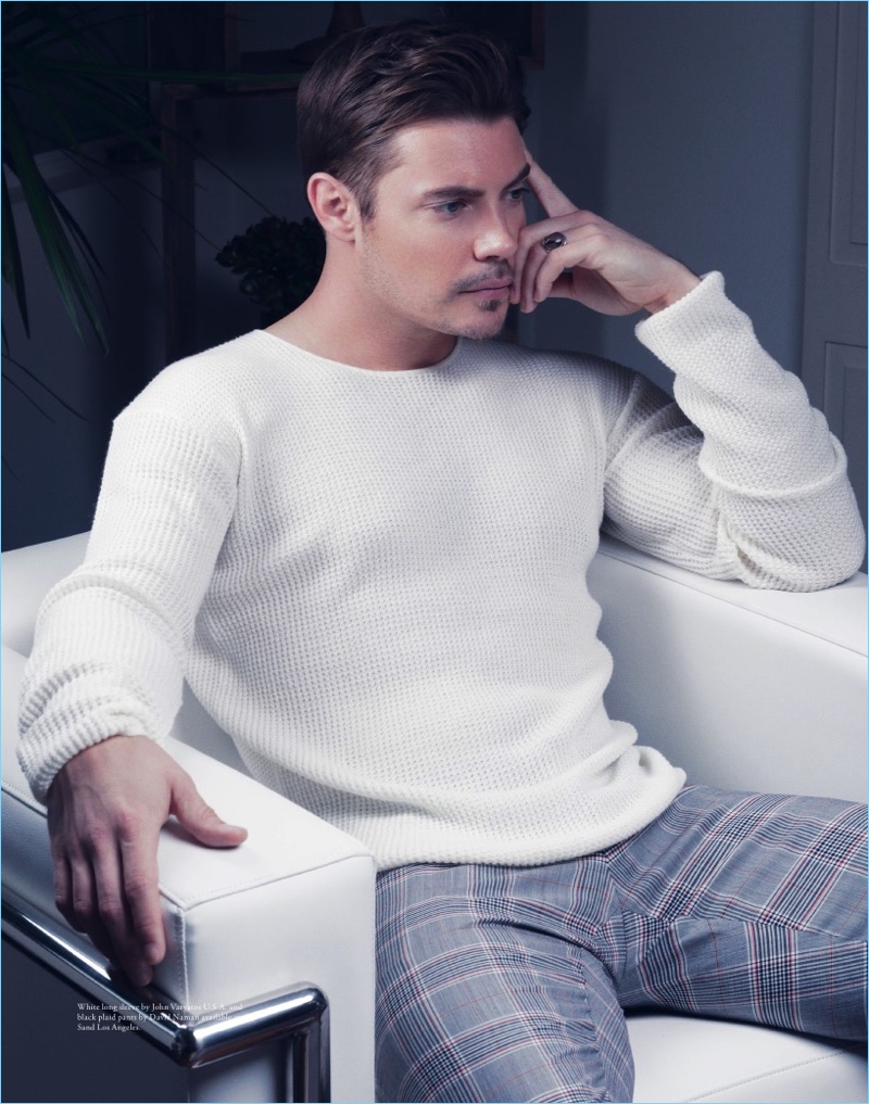 Contemplative, Josh Henderson wears a John Varvatos sweater with David Naman trousers.