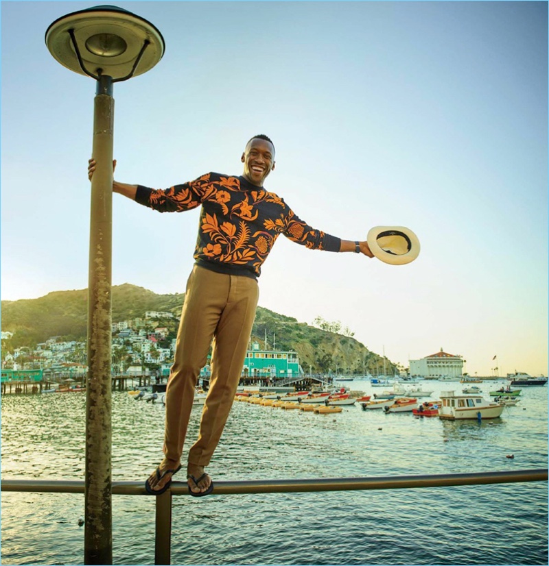 The life of the party, Mahershala Ali wears an AMI sweatshirt with Valentino pants. He also sports Havaianas flip-flops and a Borsalino hat.