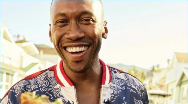 Mahershala Ali Visits Catalina Island with GQ, Rocks Tropical Summer Style Grabbing a bite to eat, Mahershala Ali wears a tropical print bomber jacket and denim jeans by Gucci.