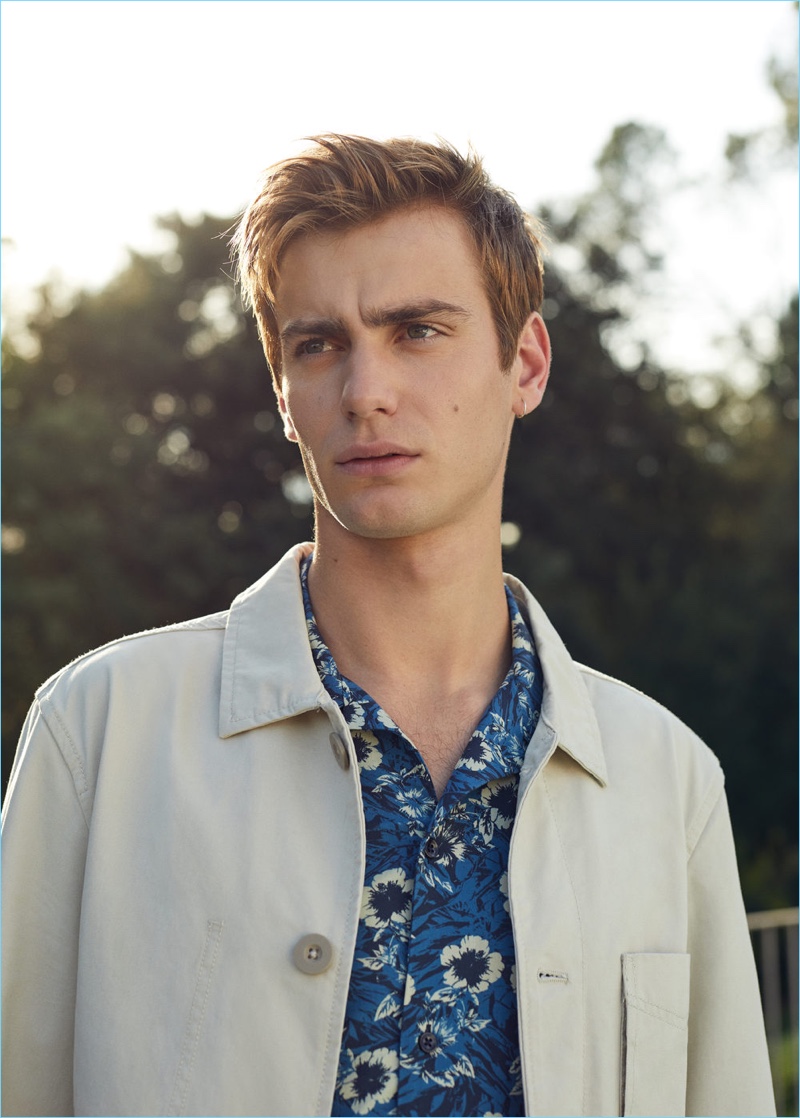 British model Ben Allen wears a white denim jacket with a tropical print shirt from Mango Man.