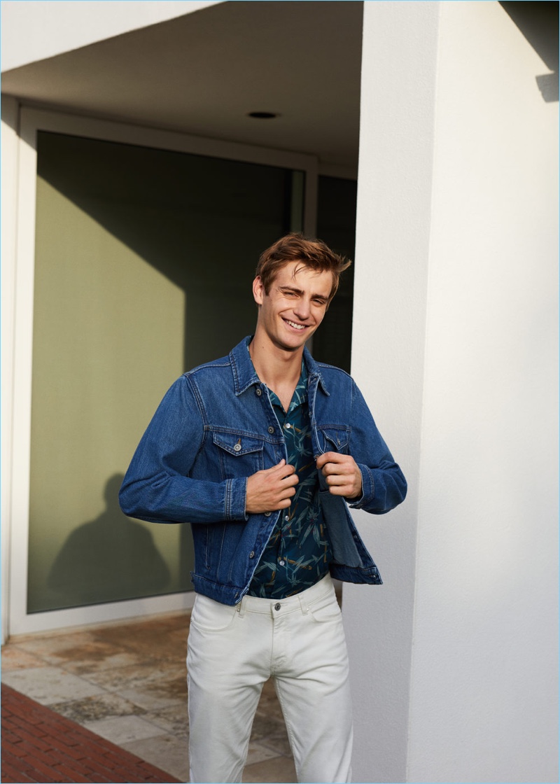 Connecting with Mango Man, Ben Allen sports a denim jacket with a print shirt and pants.