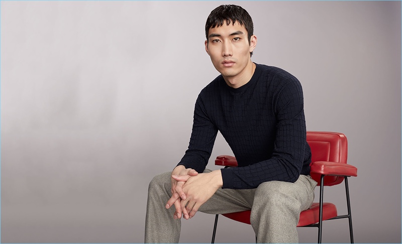Do Byungwook wears a wool-blend sweater and trousers by Giorgio Armani.