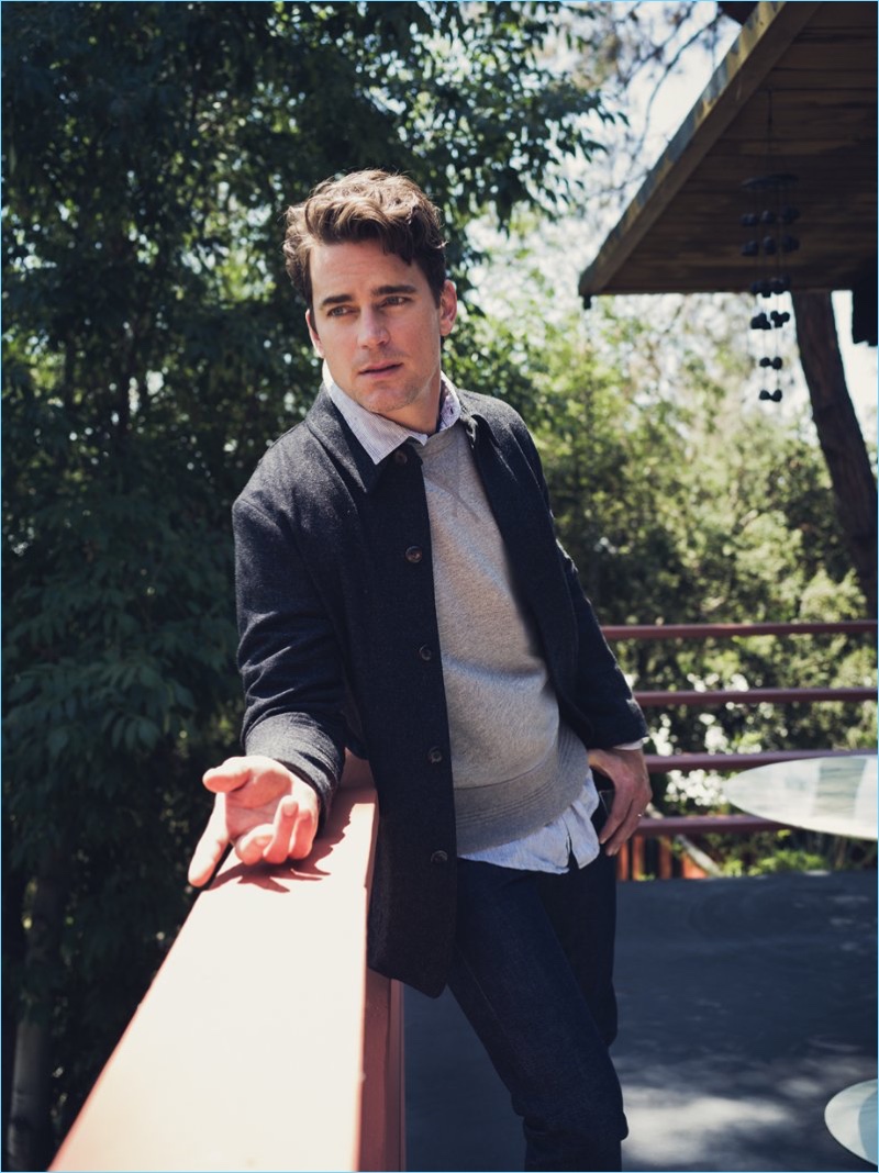 Posing for a picture outdoors, Matt Bomer wears a Private White V.C. wool jacket and Albam sweatshirt. Bomer's look is complete with an Onia linen shirt and A.P.C. Petit New Standard slim-fit selvedge denim jeans.