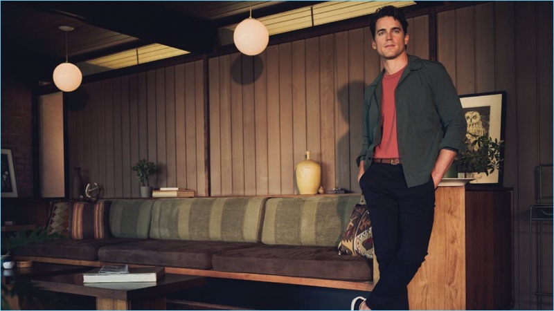 Relaxing, Matt Bomer wears a NN07 overshirt, Folk t-shirt and AMI chinos. The American actor also sports a Burberry leather belt and Dries Van Noten sneakers as well.