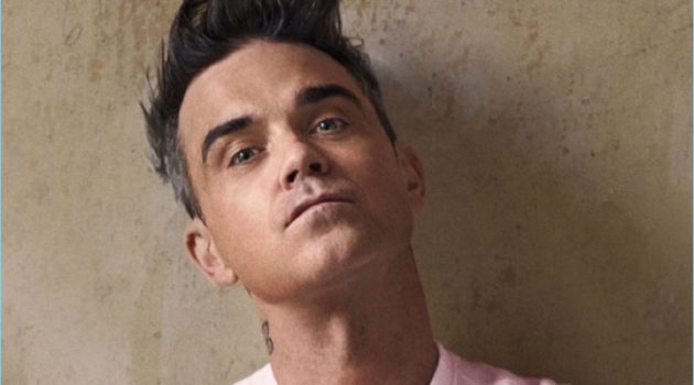 Robbie Williams Collaborates with Marc O'Polo, Stars in New Campaign Robbie Williams wears a pink logo sweater from his Marc O'Polo collaboration.