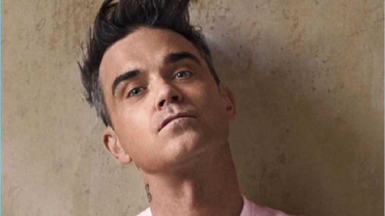Robbie Williams wears a pink logo sweater from his Marc O'Polo collaboration.