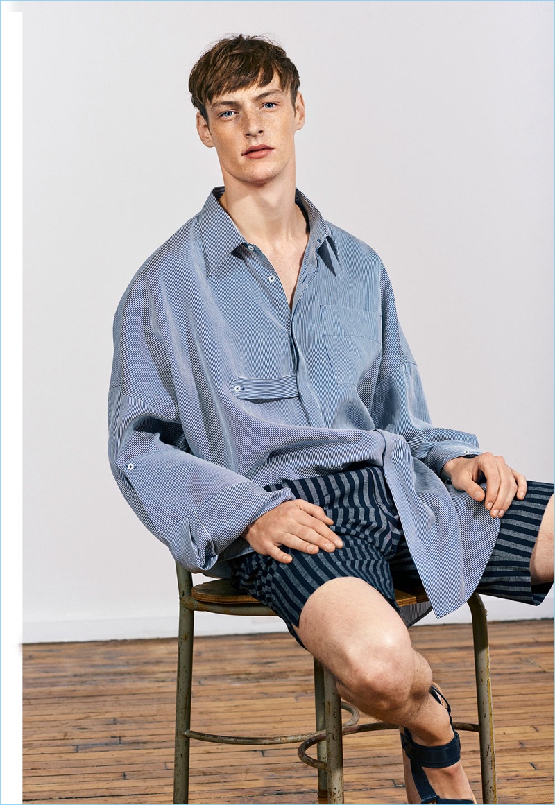 Embracing the oversize trend, Roberto Sipos wears a shirt with striped Bermuda shorts from Zara Man's Studio collection.