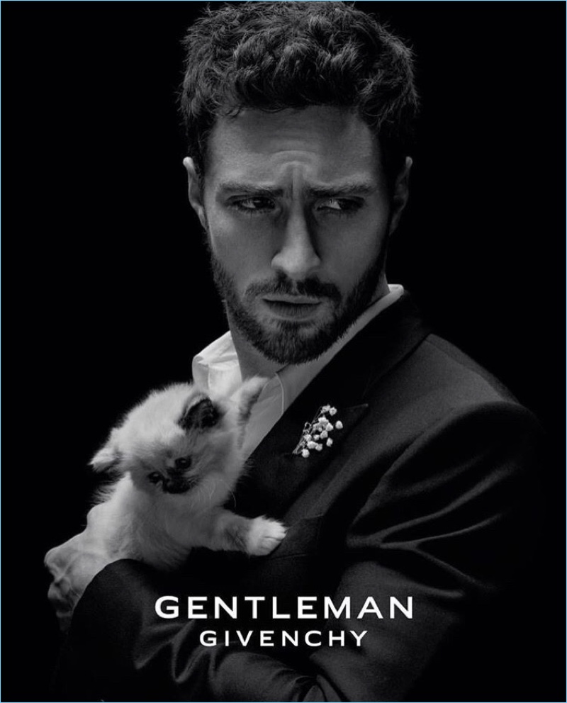 English actor Aaron Taylor-Johnson poses with a cat for the fragrance campaign of Gentleman Givenchy.