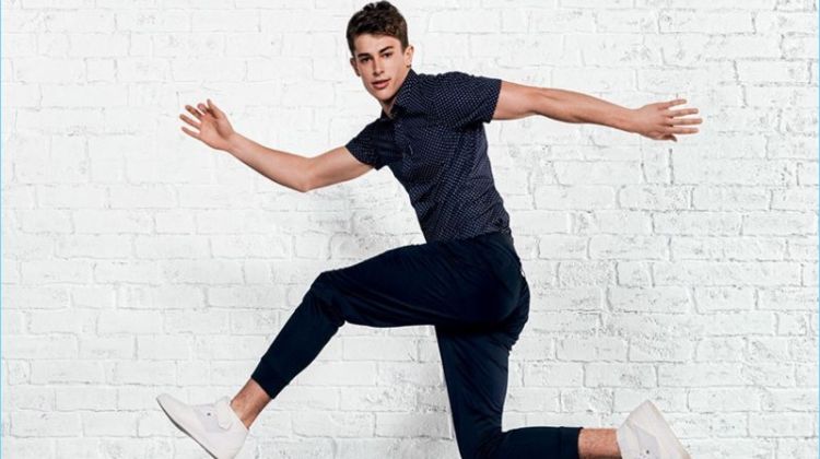 Leaping into action, Brian Altemus rocks a navy look from Armani Exchange.