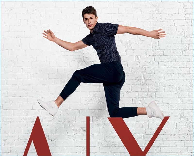 Leaping into action, Brian Altemus rocks a navy look from Armani Exchange.