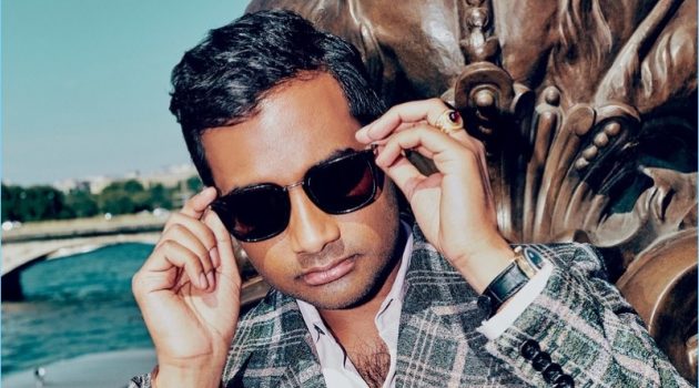 Actor Aziz Ansari wears a Gucci suit with a Berluti shirt. He also sports a Rolex watch and Saint Laurent sunglasses.