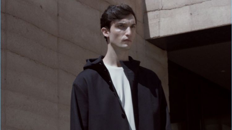 Standing tall, Max Von Isser wears a COS oversize jersey t-shirt with a parka and cotton-linen trousers.