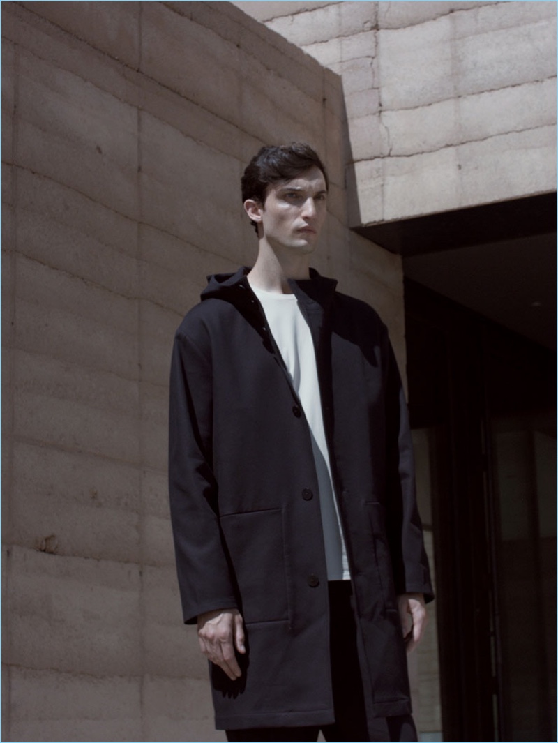 Standing tall, Max Von Isser wears a COS oversize jersey t-shirt with a parka and cotton-linen trousers.