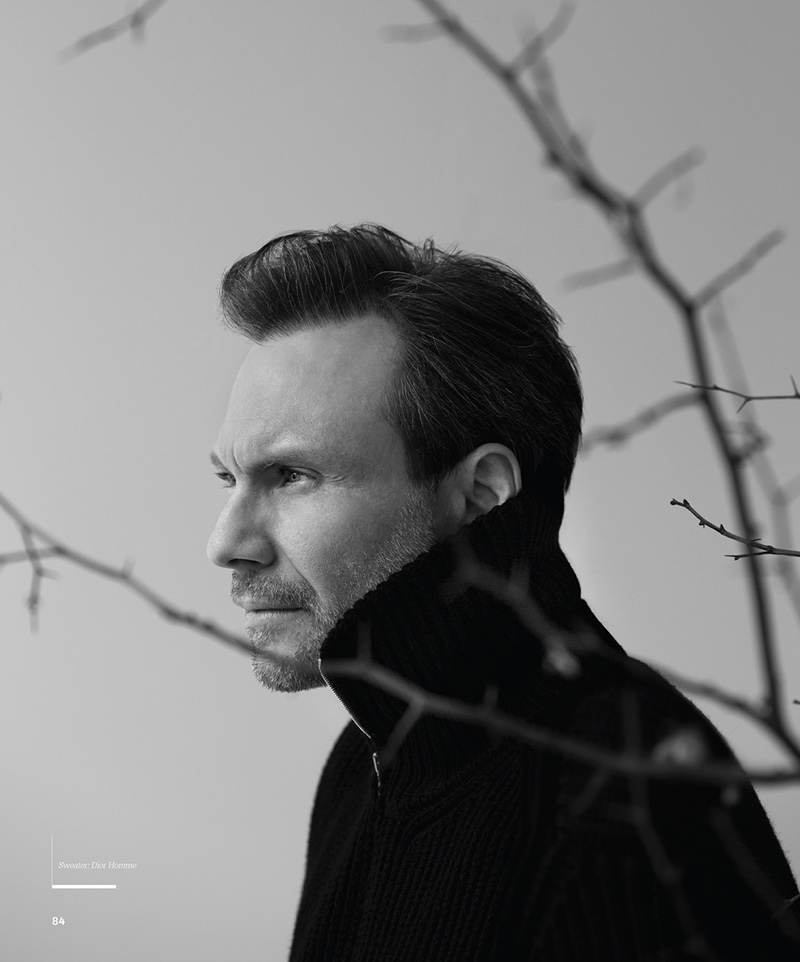 Delivering a side profile, Christian Slater wears a Dior Homme sweater.