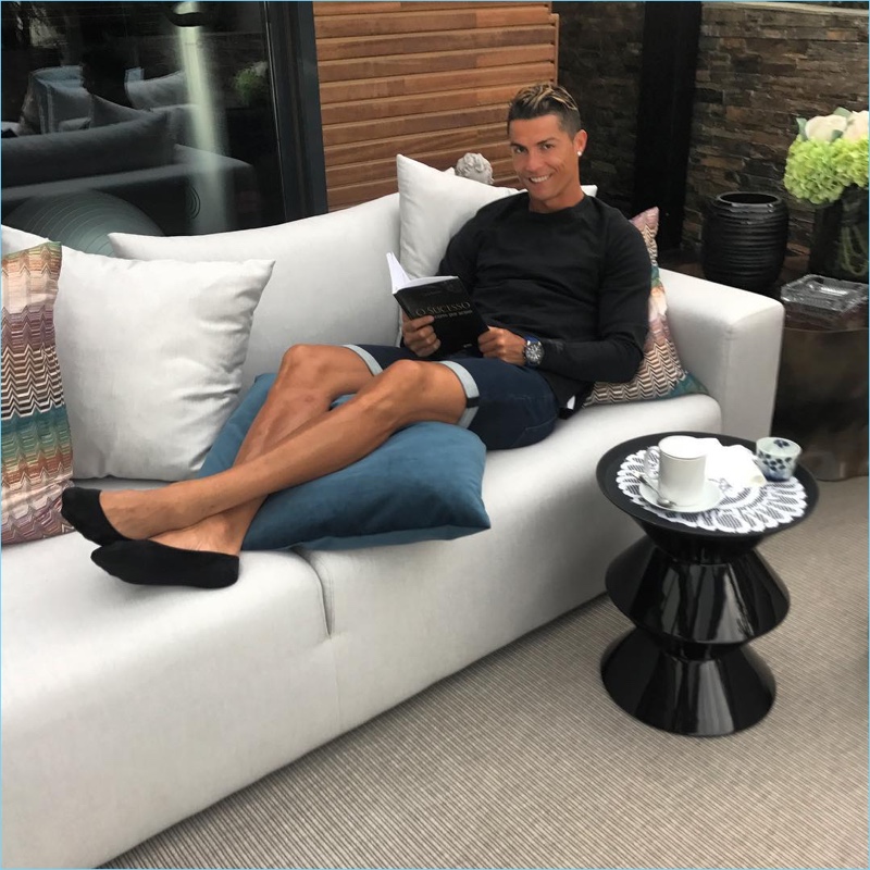 Relaxing, Cristiano Ronaldo rocks a pair of his CR7 denim shorts.