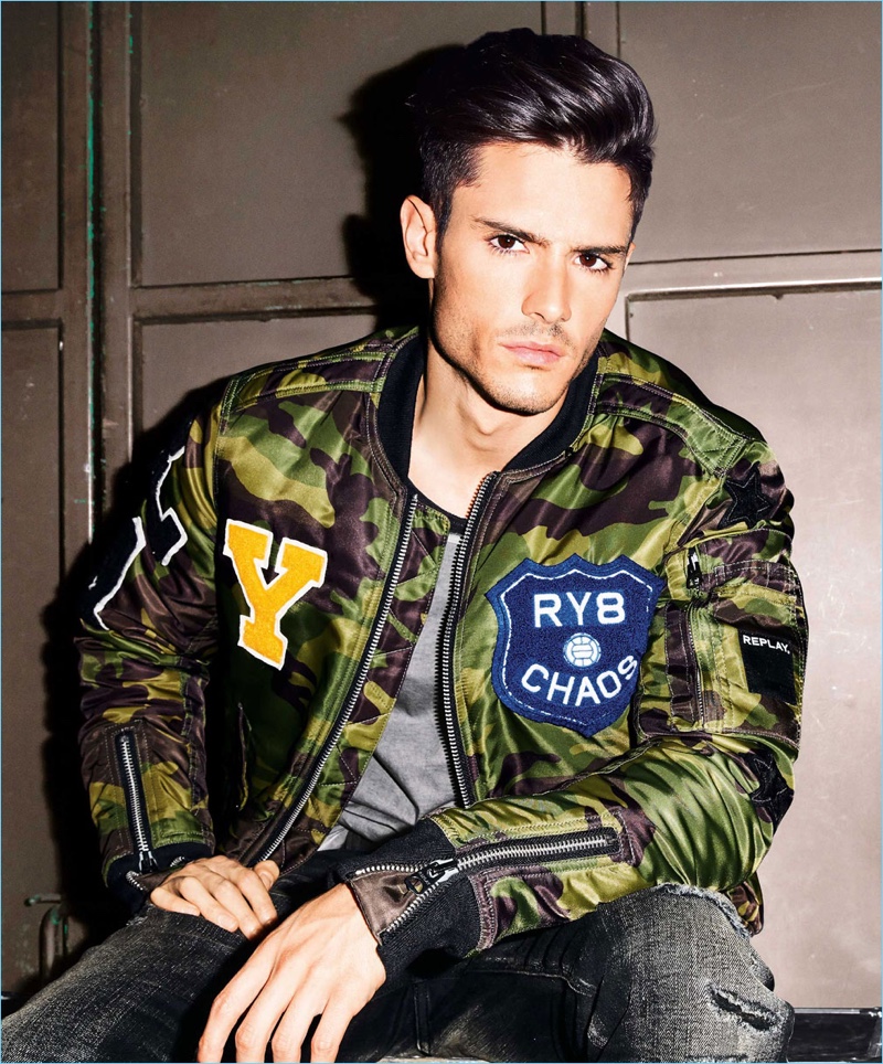 A trendy vision, Diego Barrueco models a camouflage print Replay jacket with a Lee t-shirt and LTB jeans.