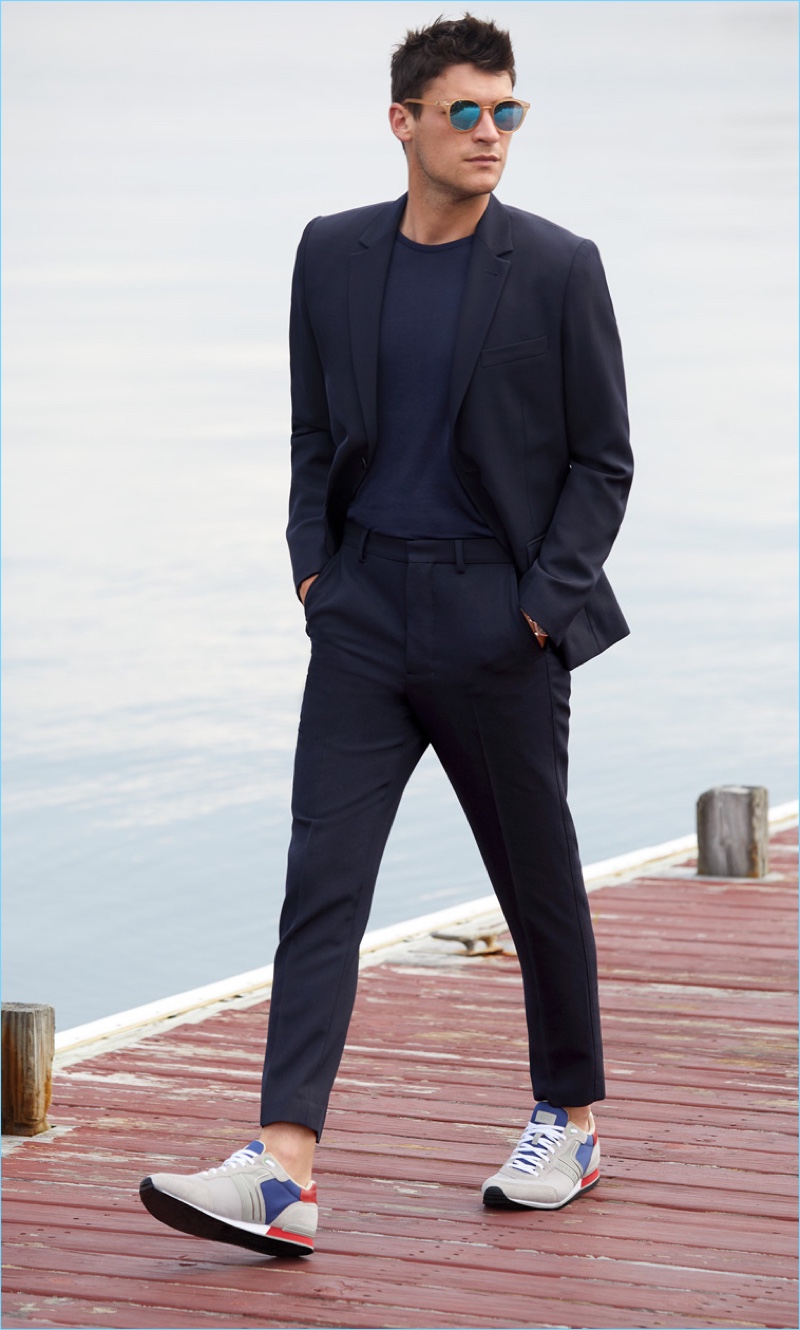 Made in the Shade: Miles Garber wears a Theory suit jacket $435 and trousers $180 with an A.P.C. sweater. He also sports Le Specs sunglasses and HUGO sneakers.