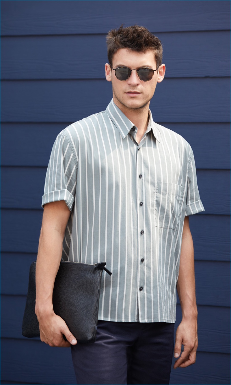 Front and center, Miles Garber wears a Vince striped shirt $225 with A.P.C. pants $275. Oliver Peoples sunglasses $455 and an Uri Minkoff leather pouch $175 complete the look.