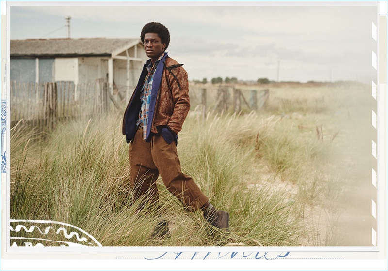 Making a case for earthy hues, Josue Comoe sports an Uma Wang bomber jacket with Ziggy Chen trousers. Josue's look is complete with an Ann Demeulemeester blazer, Gucci shirt, and Marsell boots.