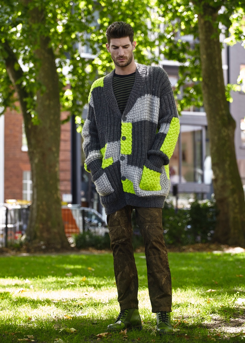 Ryan wears chunky cardigan sweater Christopher Raeburn, striped top Nanamica, pants Weekday, and boots Dr Martens.