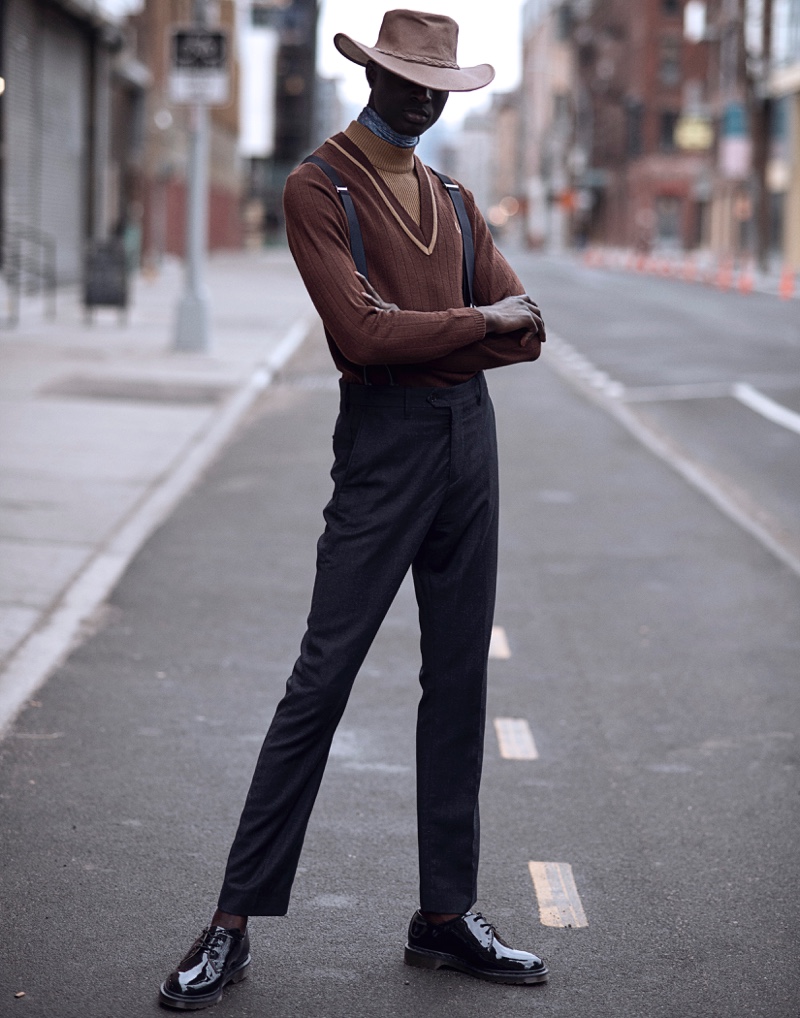 Aly wears sweater Fred Perry, trousers Acne Studios, suspenders Tommy Hilfiger, hat Minnetonka, and shoes Dr Martens.