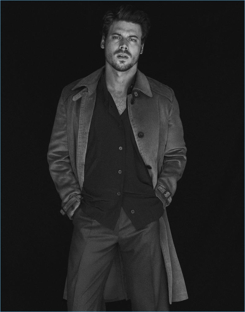 Front and center, François Arnaud wears a Prada coat. He also sports a Vivienne Westwood shirt and Caruso pants.