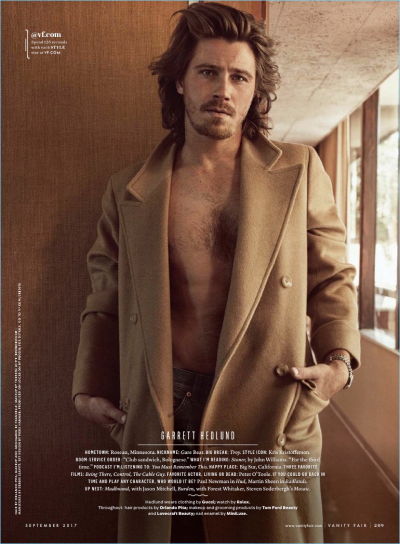 Garrett Hedlund goes shirtless in jeans and a camel coat from Gucci.