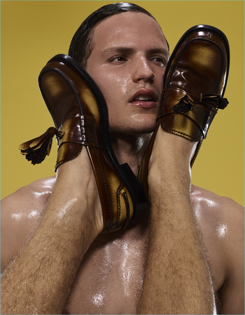 Australian model Nathaniel Visser poses with Prada's leather loafers.