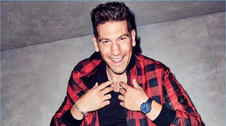 All smiles, Jon Bernthal wears a buffalo check jacket and leather pants by Versace. Bernthal also dons an Armani Exchange t-shirt and Saturdays NYC sneakers.