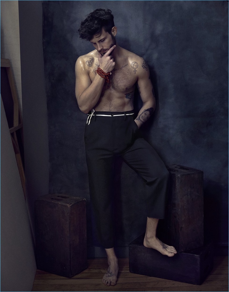 Wearing Gucci trousers, Nico Tortorella stars in a photo shoot for Paper magazine.